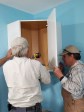 Max and Mark installing a wall cabinet